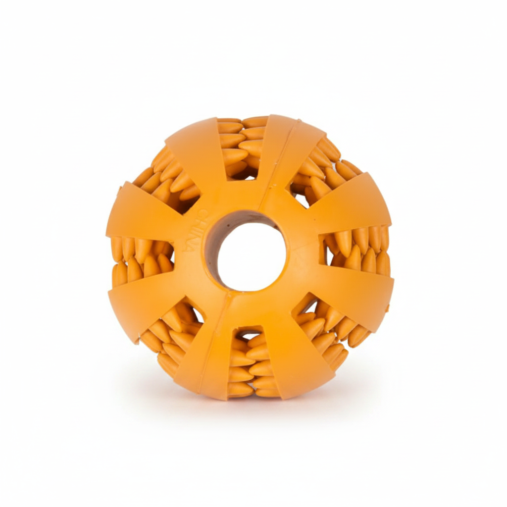 An orange textured rubber dog toy ball with a central hole and radial textured segments, shown on a plain white background.