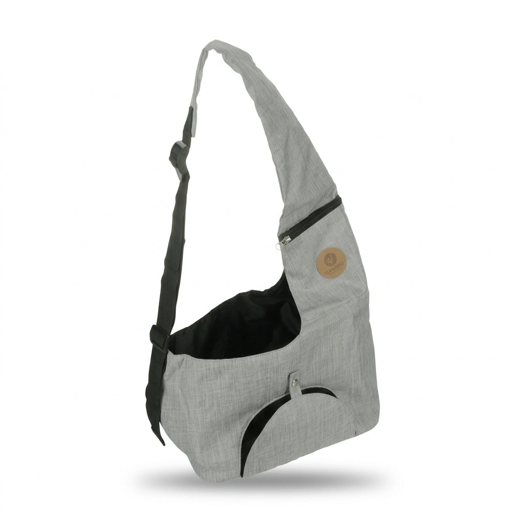 A light gray heathered fabric shoulder bag with black accents, including a black interior lining, a black curved trim detail, and a black adjustable strap. It features a small circular tan patch on the upper right side.