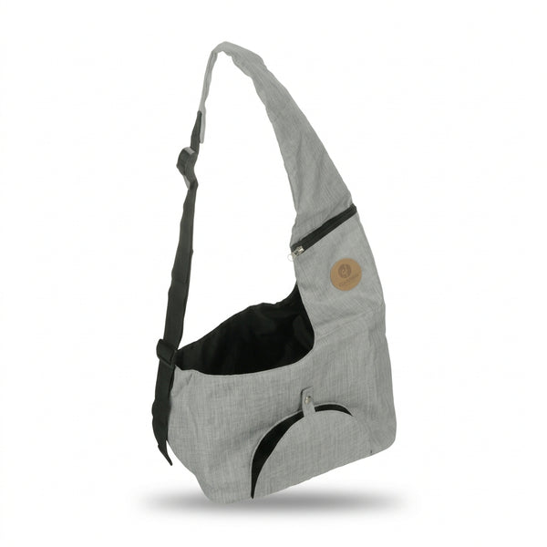 A light gray heathered fabric shoulder bag with black accents, including a black interior lining, a black curved trim detail, and a black adjustable strap. It features a small circular tan patch on the upper right side.