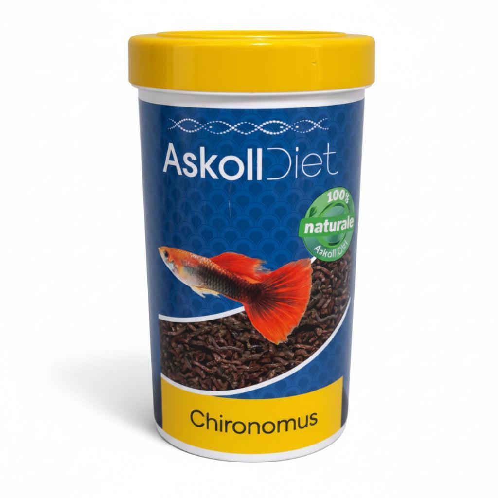 A cylindrical container of Askoll Diet Chironus blood worms fish food, featuring a blue label with a picture of a red and orange guppy, a yellow lid, and a green '100% naturale' badge.