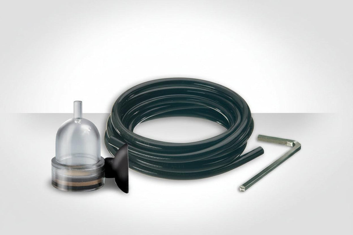 Askoll Co2 coiled black hose with a clear bell-shaped connector, a black fitting, and a metal wrench on a light gray gradient background.