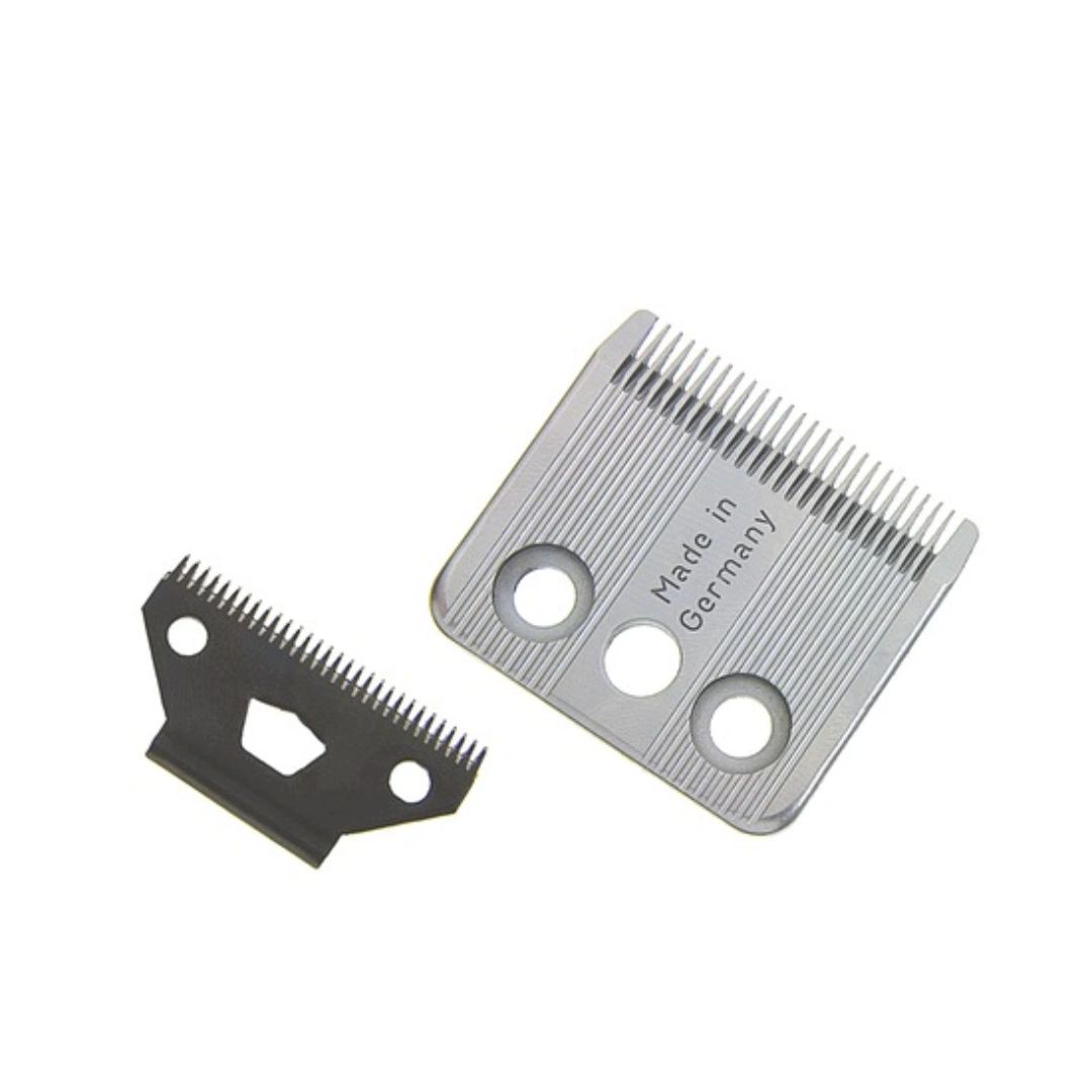 Two metal clipper blades, one silver and one black, shown on a plain white background. The silver blade has 'Made in Germany' printed on it.
