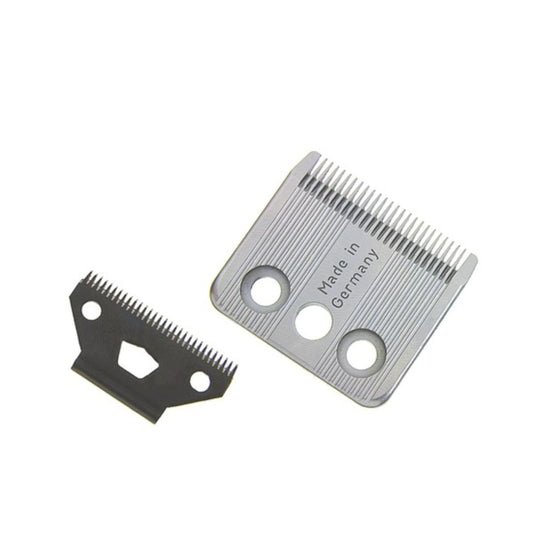 Two metal clipper blades, one silver and one black, shown on a plain white background. The silver blade has 'Made in Germany' printed on it.
