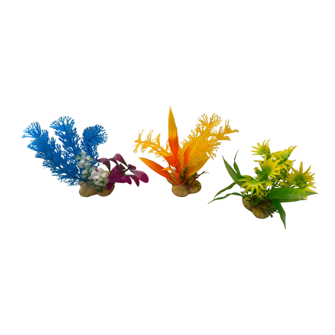Three artificial aquarium coral plants in blue, orange-yellow, and green, each mounted on a brown base, displayed against a plain white background.