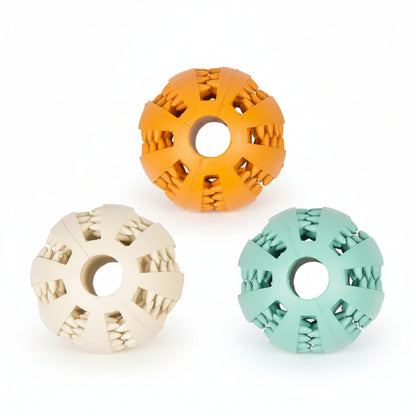 Three textured dental dog ball toys in orange, beige, and green on a white background