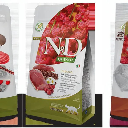 N&D Quinoa Urinary cat food bag featuring duck, cranberry, and chamomile imagery on a white and olive green package.