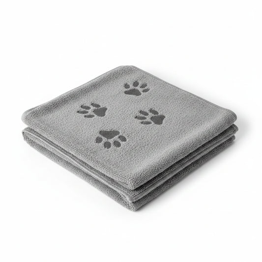 A folded gray microfiber dog grooming towel with three dark gray paw prints, shown on a plain white background.