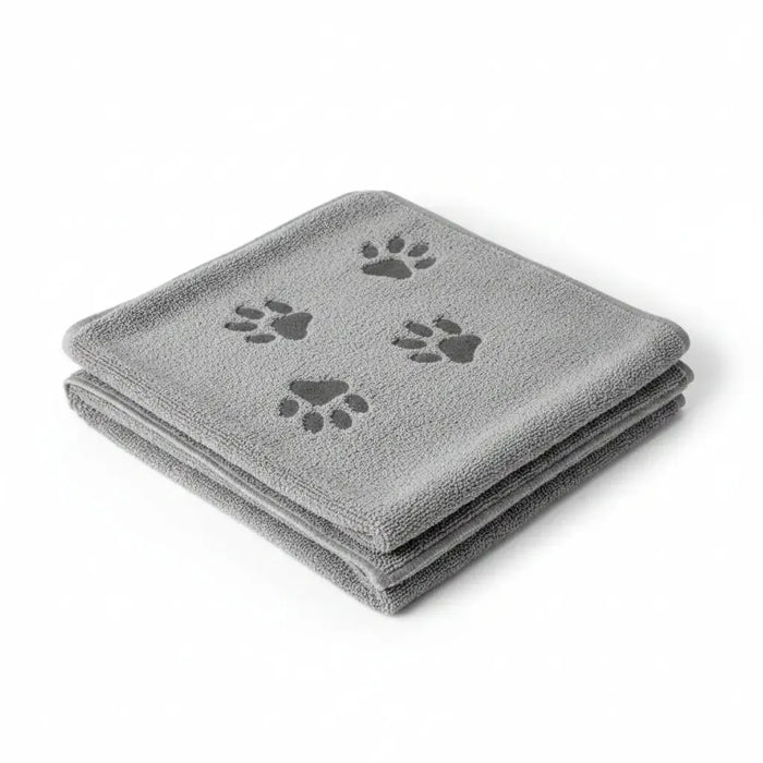 A folded gray microfiber dog grooming towel with three dark gray paw prints, shown on a plain white background.