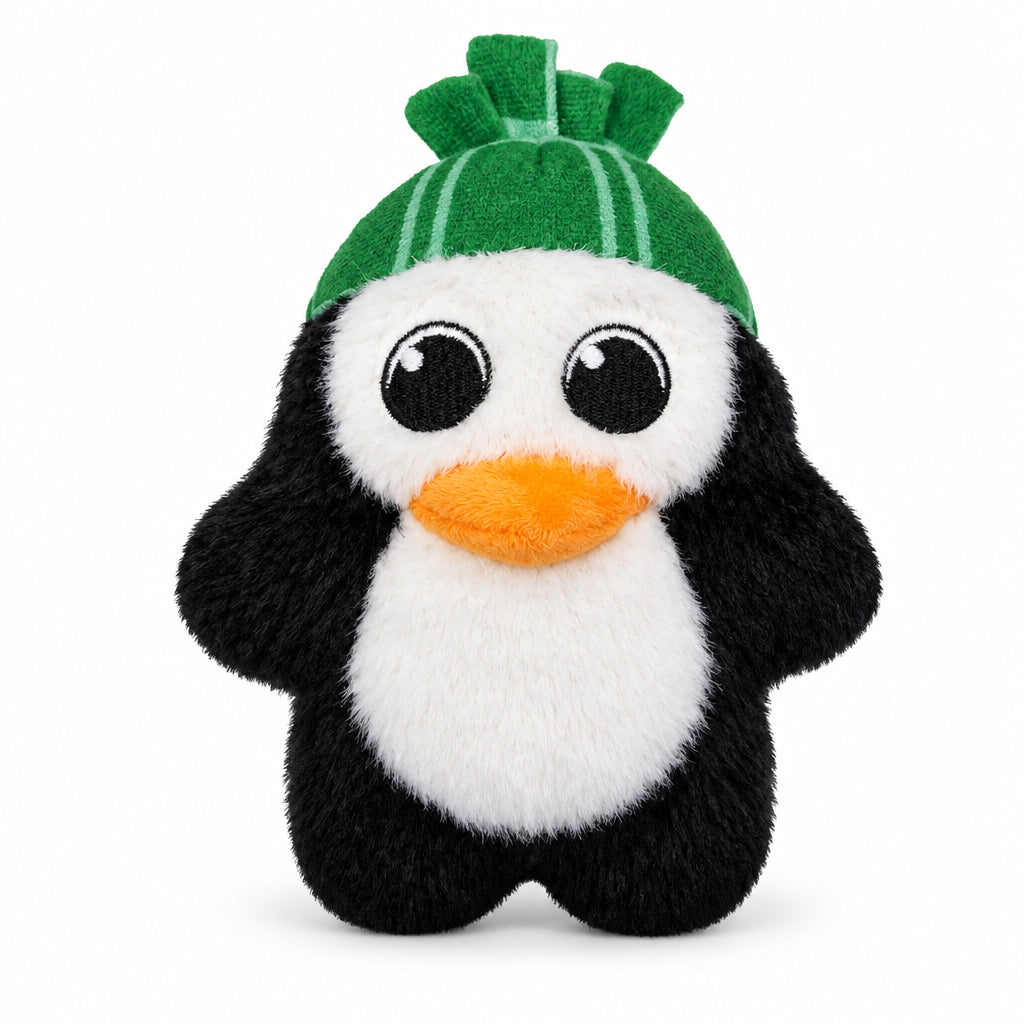 A plush penguin toy with black and white fur, a bright orange beak, and a green hat, shown on a white background with dimension arrows and text indicating 7 inches tall by 5.5 inches wide.