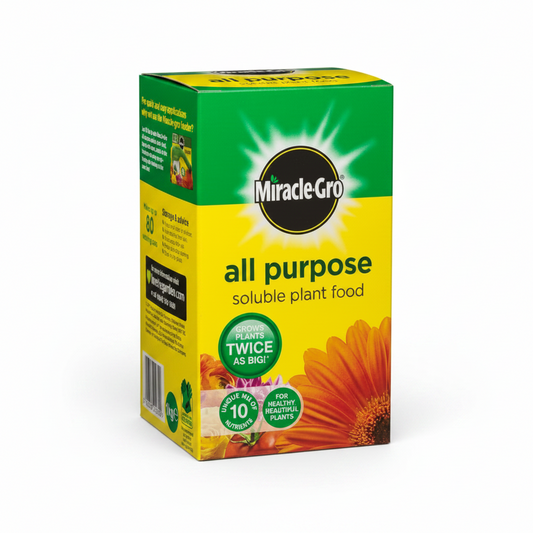 A box of Miracle-Gro All Purpose Soluble Plant Food on a plain white background. The packaging is primarily yellow and green with a black circular logo and an illustration of an orange flower.