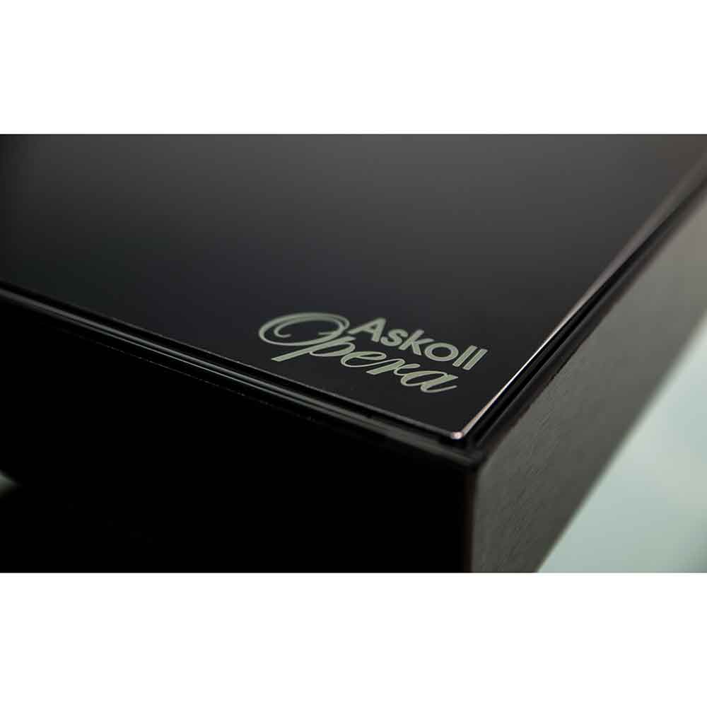 Close-up of a glossy black rectangular Aquarium with the silver script logo 'Askoli Opera' on the corner, set against a white background.