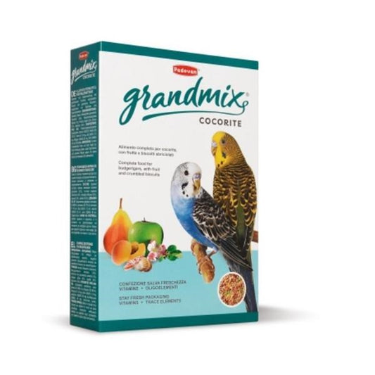 A box of Pedigree Grandmix Cocorite birdseed, featuring a white and teal packaging design with illustrations of a blue and yellow budgerigar and fresh fruits.