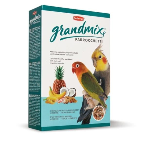 A box of Pedevita Grandmix Parrocchetti bird food, featuring illustrations of two cockatoos and fruit on the front, set against a plain white background.