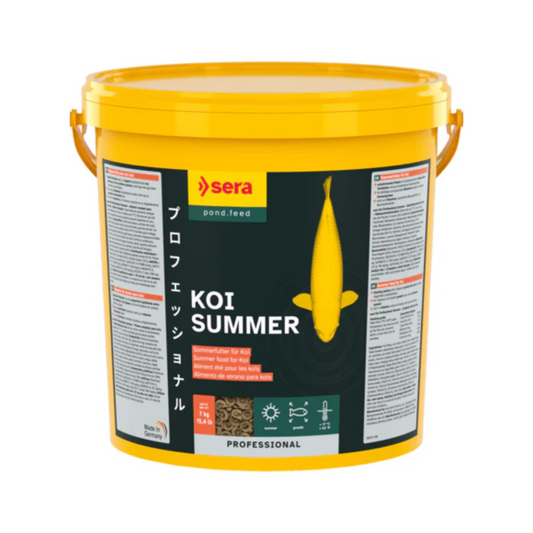 A yellow bucket of Sera Koi Summer pond feed supplement with a black label, shown on a plain white background.