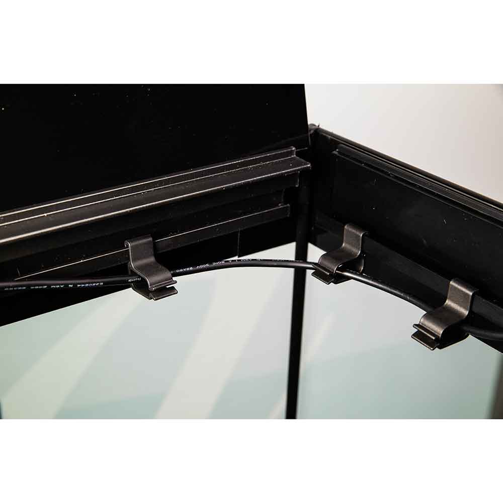 Close-up of a black metal frame or rack corner with two dark clips holding a cable, set against a plain light background.
